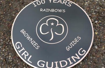 Bronze reverse engraved, and backfilled black. 3 mm thick x 75 cm in diamater with studs and template on the rear